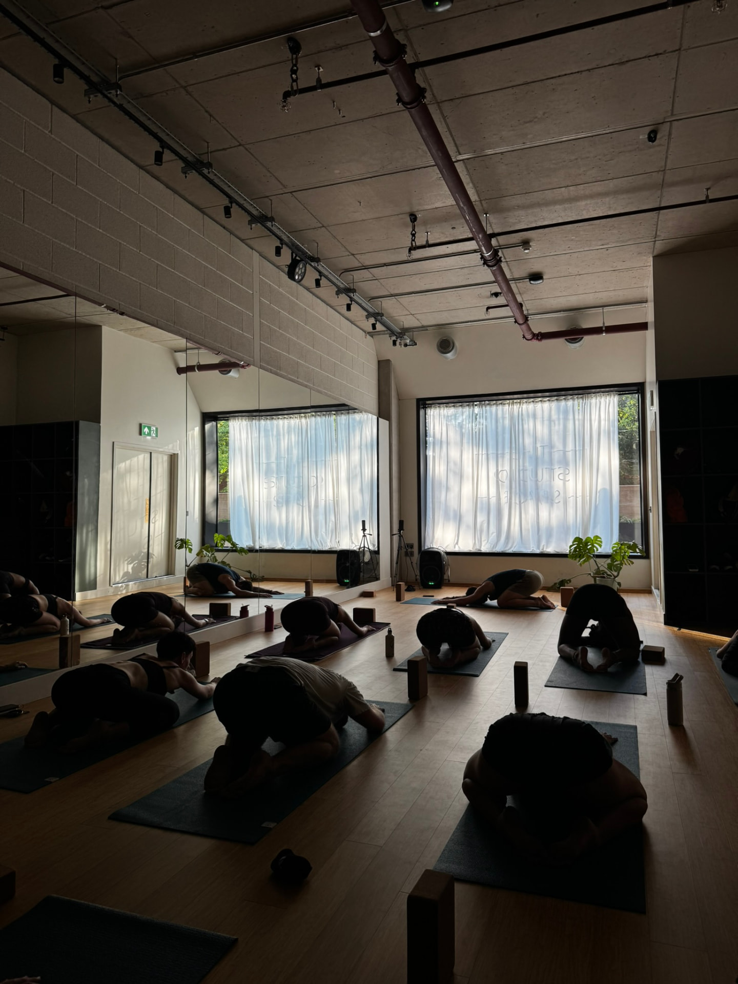 Students resting in child's pose during a yoga class in White City