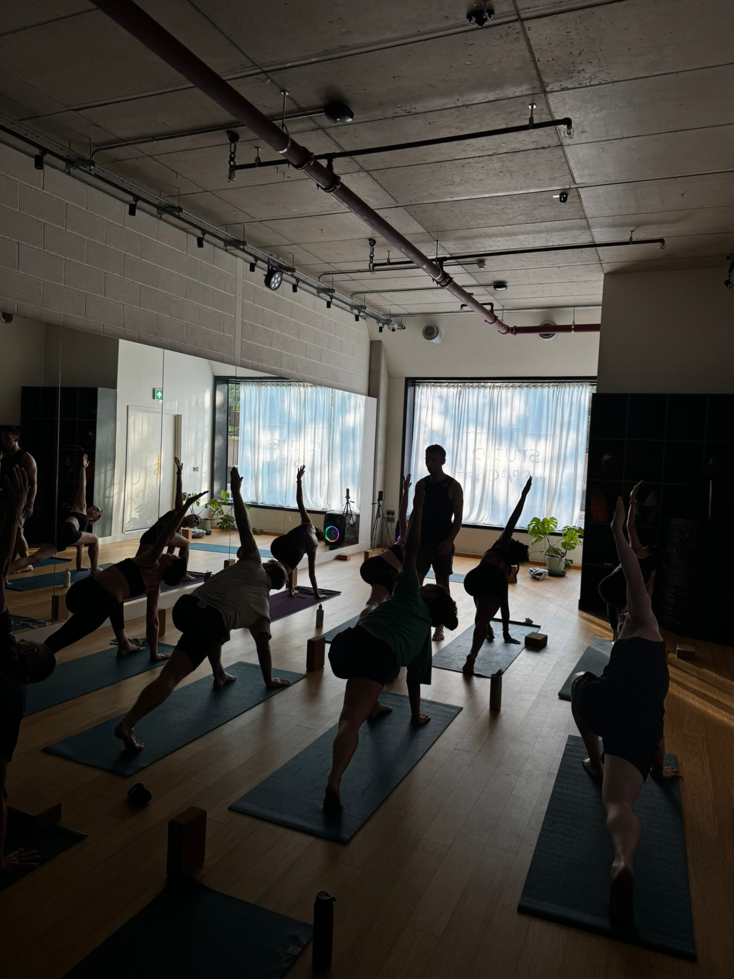 Extended side angle pose in a Wednesday evening yoga class near Television Centre