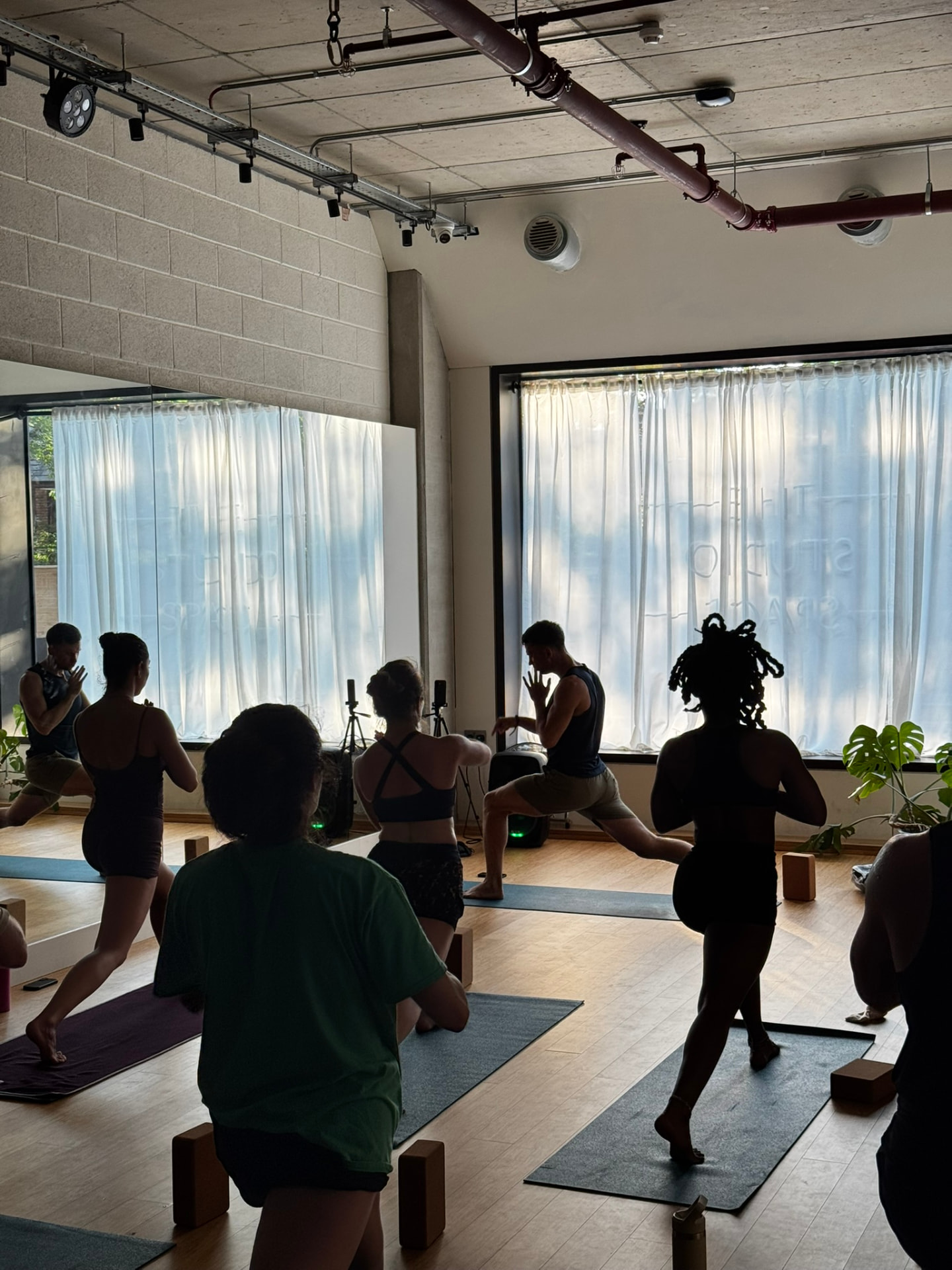 Danny Mullan teaching a standing sequence at a White City yoga class